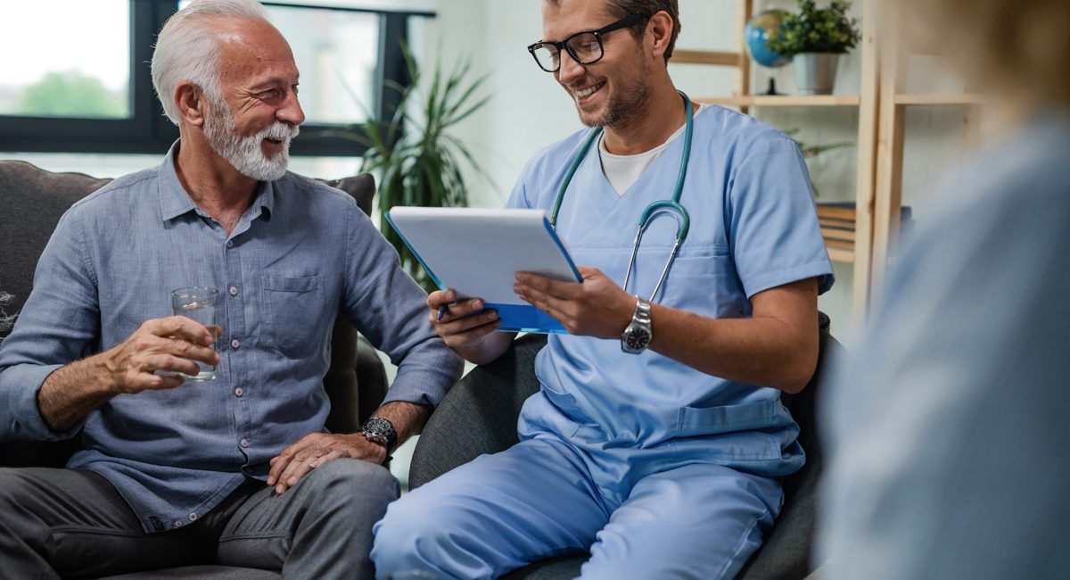 A primary care physician reviewing paperwork with a patient in El Paso.