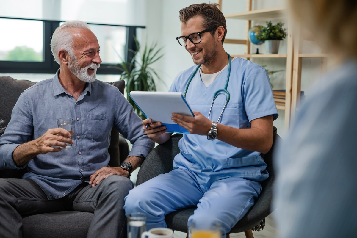 A primary care physician reviewing paperwork with a patient in El Paso.